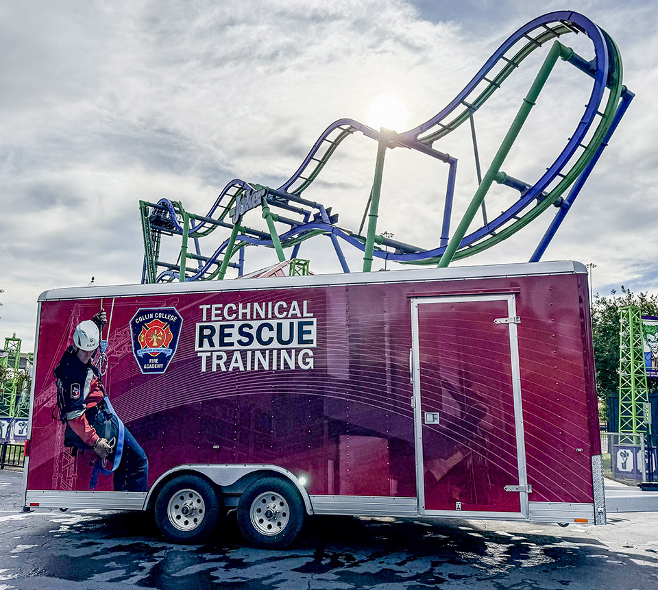 The Collin College Technical Rescue Trailer sits in front of a Six Flags ride. 
