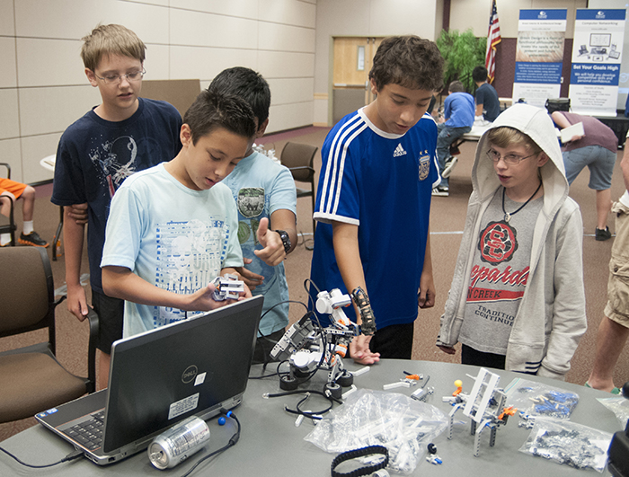 A group of middle school students work on a STEM project at a Collin College summer camp.