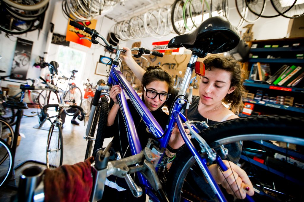 two students working on a bike