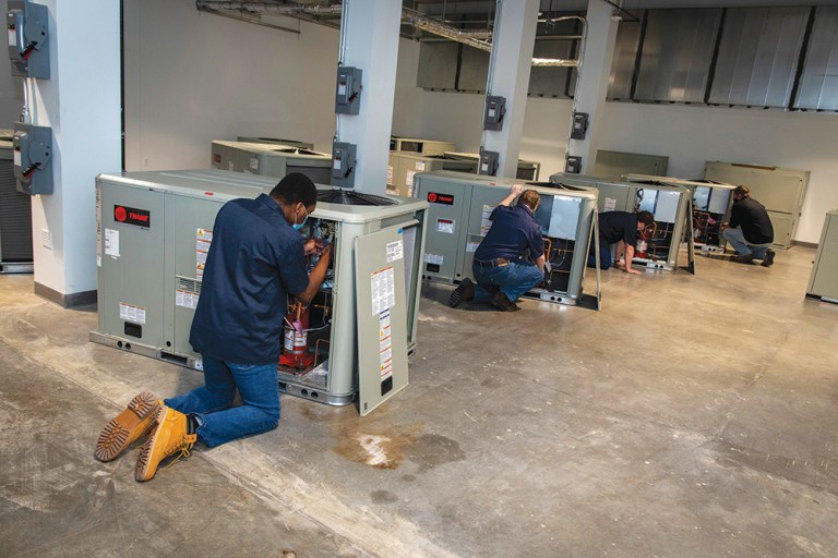 Students training on donated HVAC units.